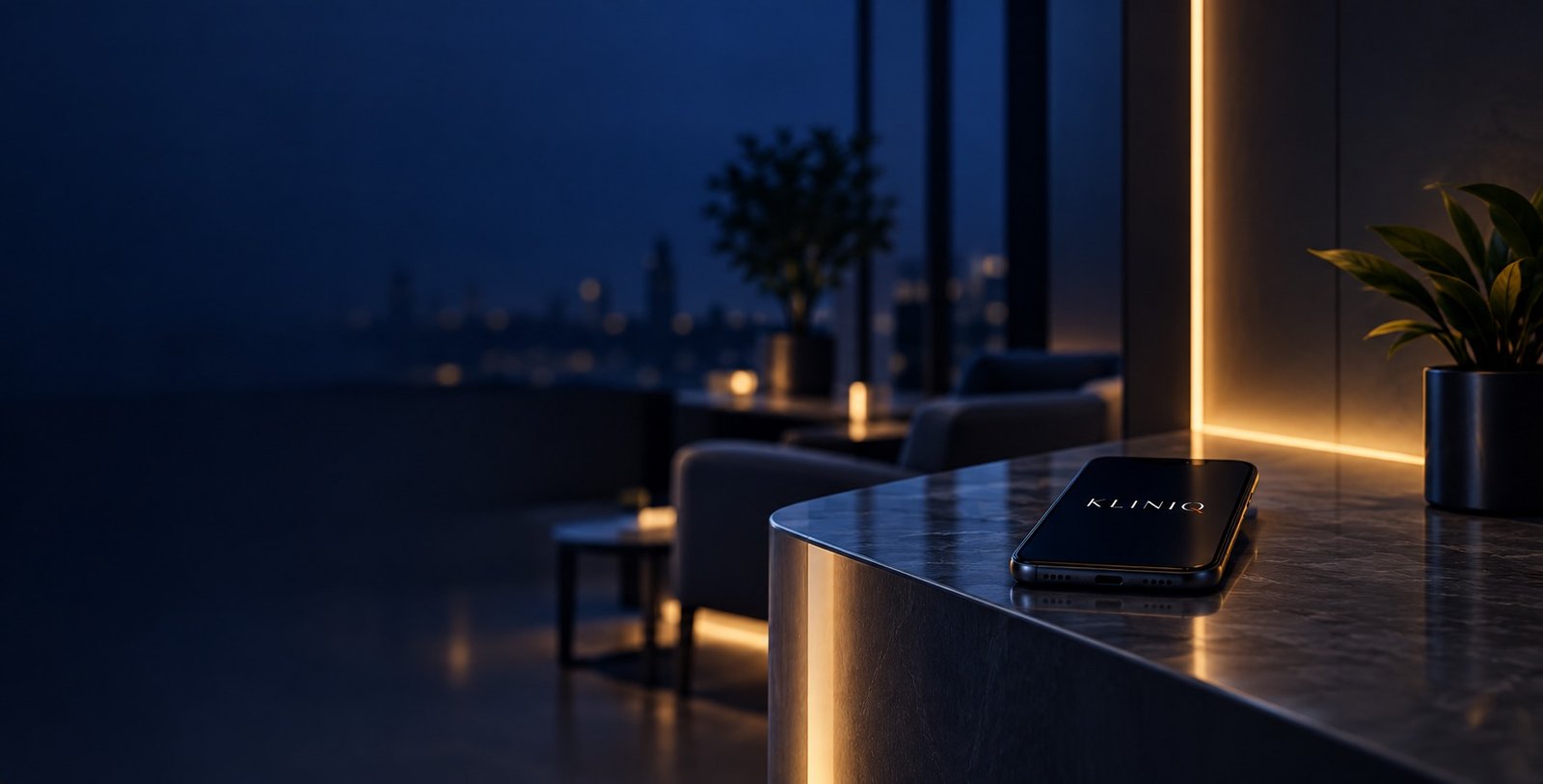 A reception counter at night, lit by a warm strip light, a phone resting on the stone showing the KlinIQ name